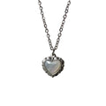 Heart-shaped pendant necklace with fresh water pearl inset on a light gray background