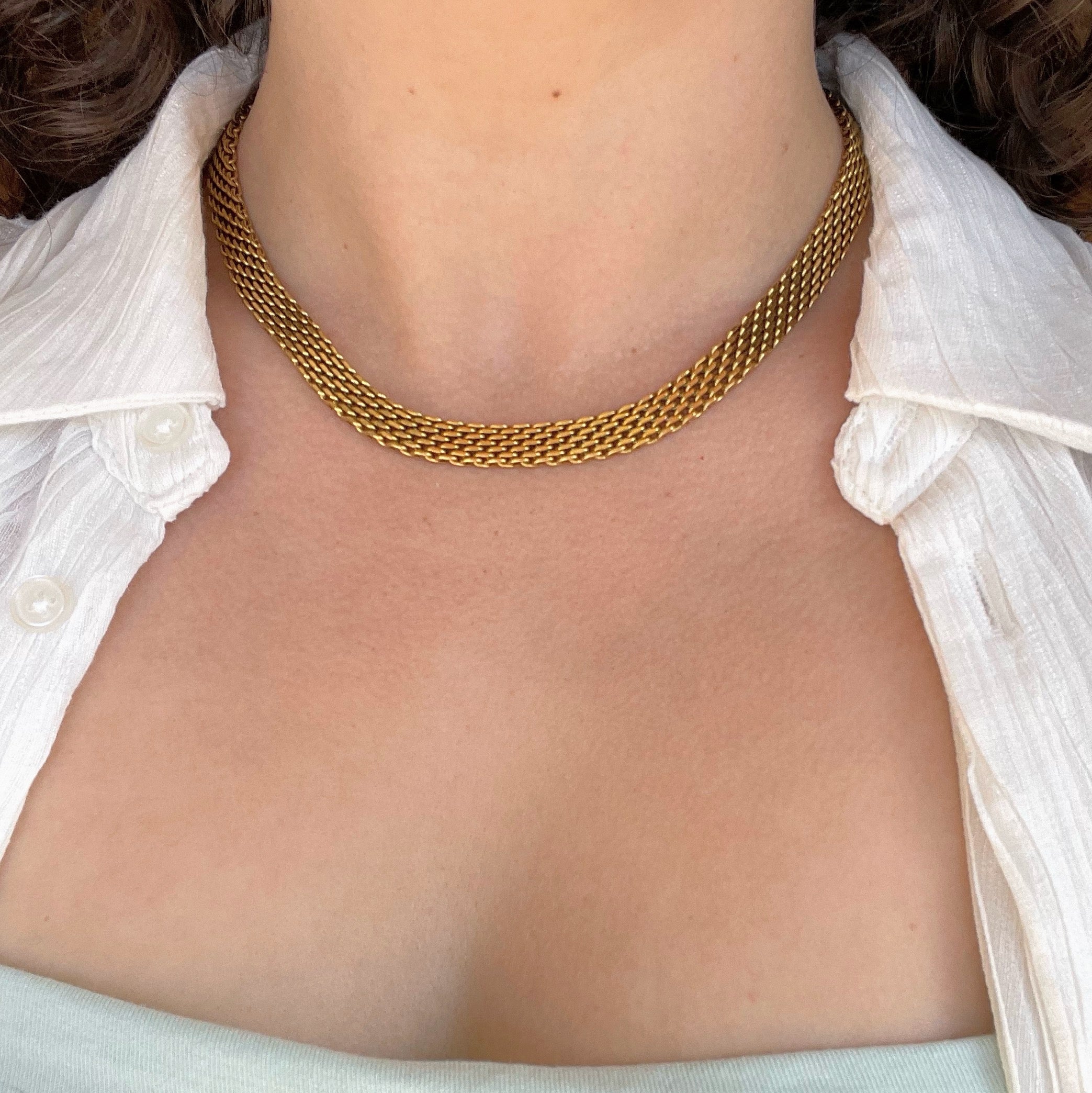 Woman wearing gold mesh choker necklace, hypoallergenic stainless steel.