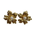 A pair of gold flower-shaped stud earrings with white pearl centres. 