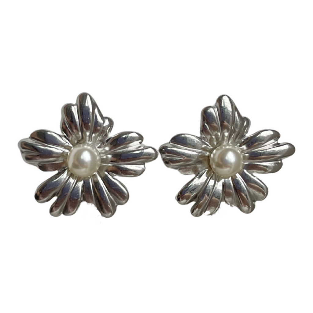 A pair of silver flower shaped stud earrings with pearl centres. 